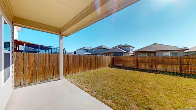 a view of a house with backyard and deck