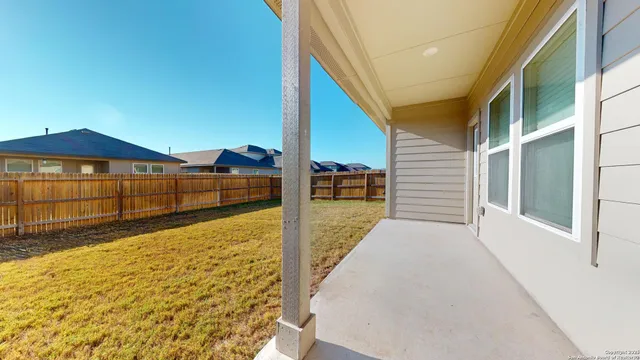 a view of a house with a wooden deck