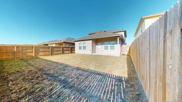 a view of a house with a backyard