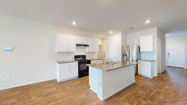 a kitchen with a sink stove and refrigerator