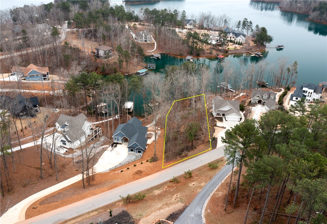 Lot 17 Retreat Pointe Road West Union, SC 29696 - Photo 20 of 22 This aerial perspective showcases a lakeside community with mature trees and tranquil waters.