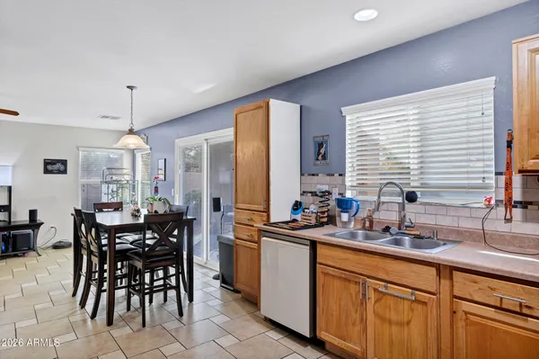 a kitchen with sink a window and dining table