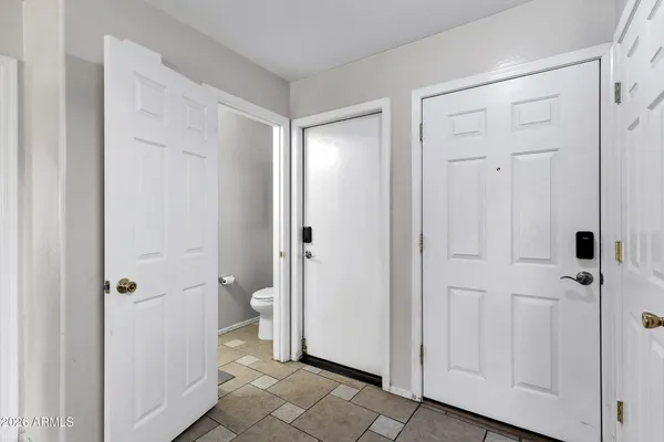 a bedroom with a bed and painting on the wall