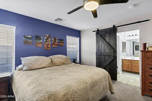 a bedroom with a bed and a desk