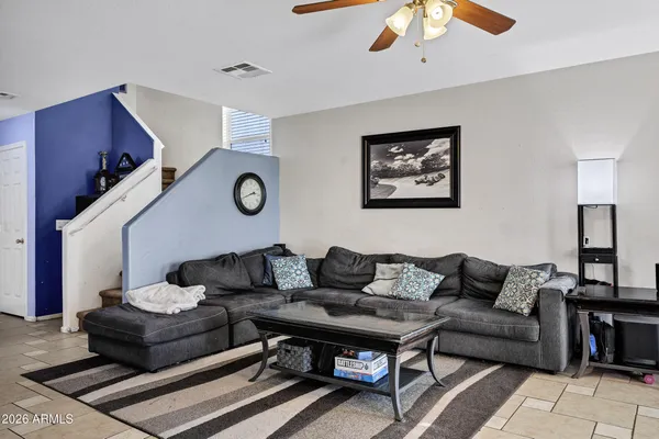 a living room with furniture and wooden floor