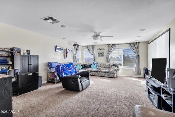 a living room with furniture a window and a flat screen tv