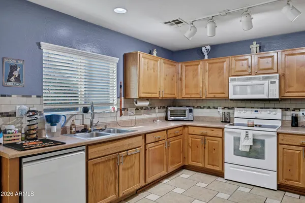 a kitchen with a sink stove and cabinets