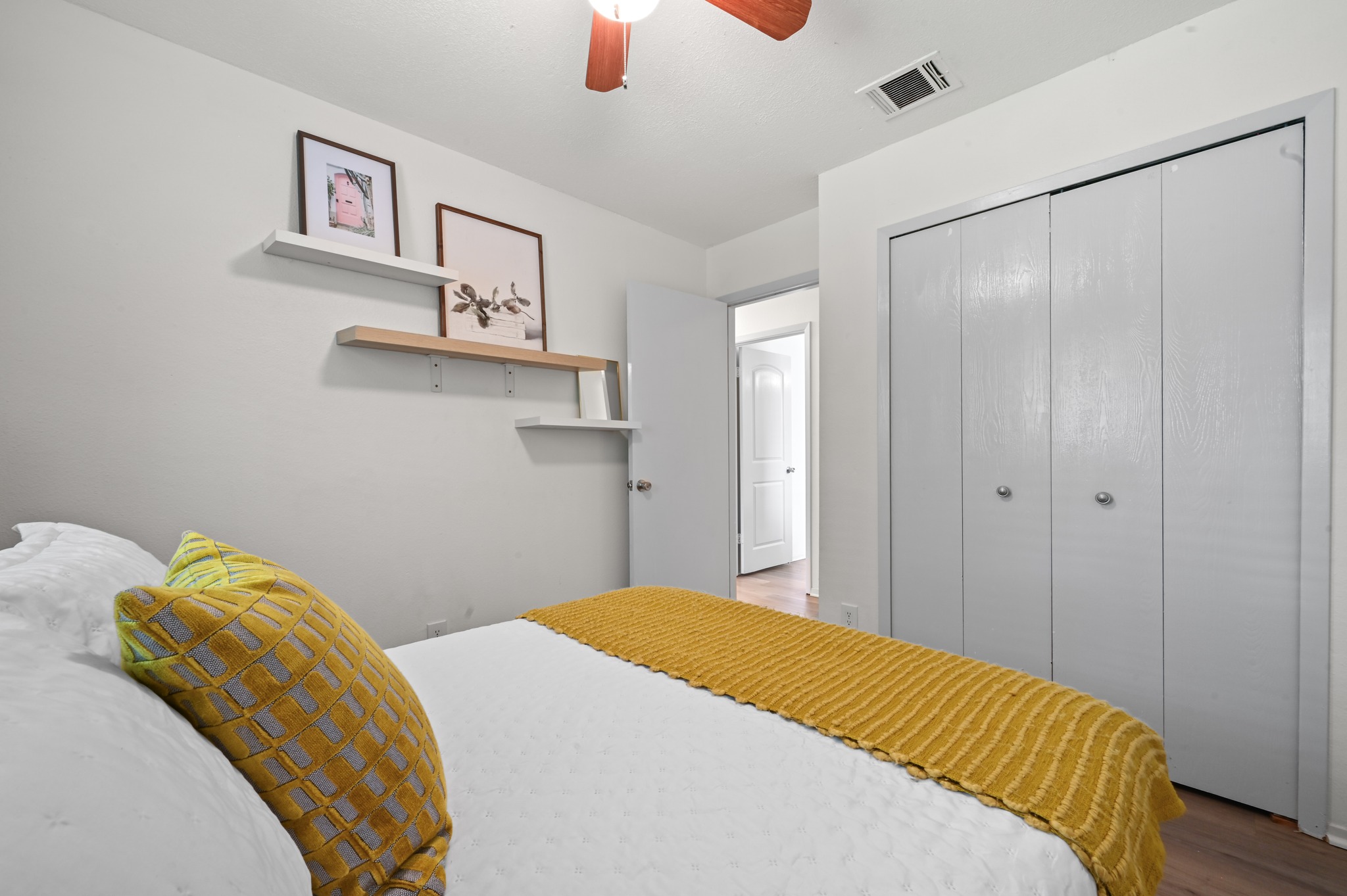 6805 Rearden Road Austin, TX 78745 - Photo 19 of 26 A comforting bedroom features built-in closet storage and a natural wood ceiling fan for year-round comfort.