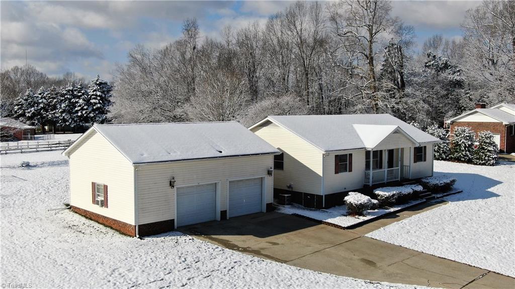 This view of property shows the attached garage and also the smaller wired shop behind - it also has heater and a/c.