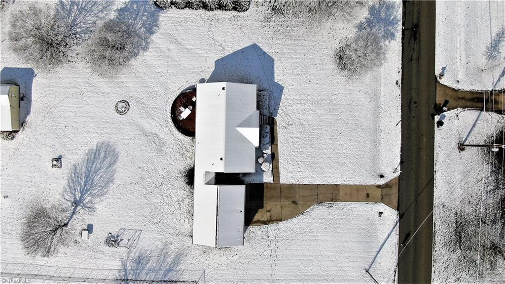 Aerial of house and shows front of wired outbuilding.