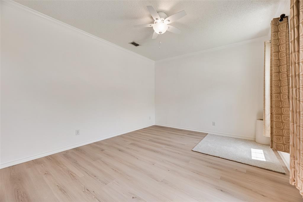 1406 West Peters Colony Road Carrollton, TX 75007 - Photo 23 of 29 an empty room with a ceiling fan and carpet