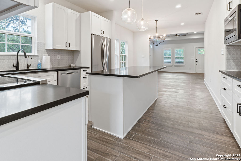 1125 Cedar Grove Trail Spring Branch, TX 78070 - Photo 12 of 23 a kitchen with stainless steel appliances granite countertop a refrigerator a sink and a stove
