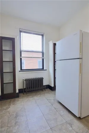 a kitchen with a refrigerator and a more cabinets