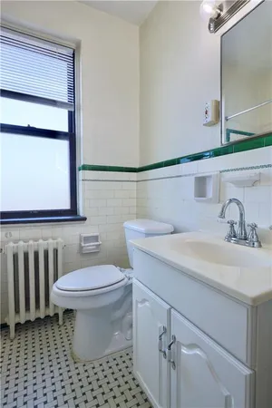 a bathroom with a sink a toilet and mirror