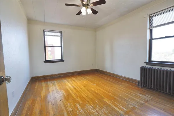 wooden floor in an empty room with a window