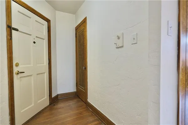 a view of a hallway with wooden floor