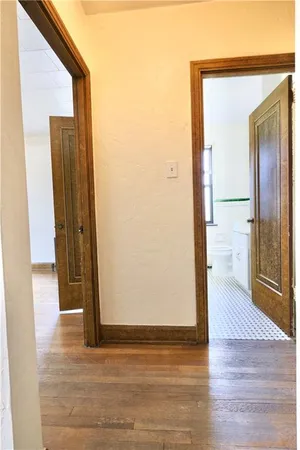 a view of a hallway with wooden floor