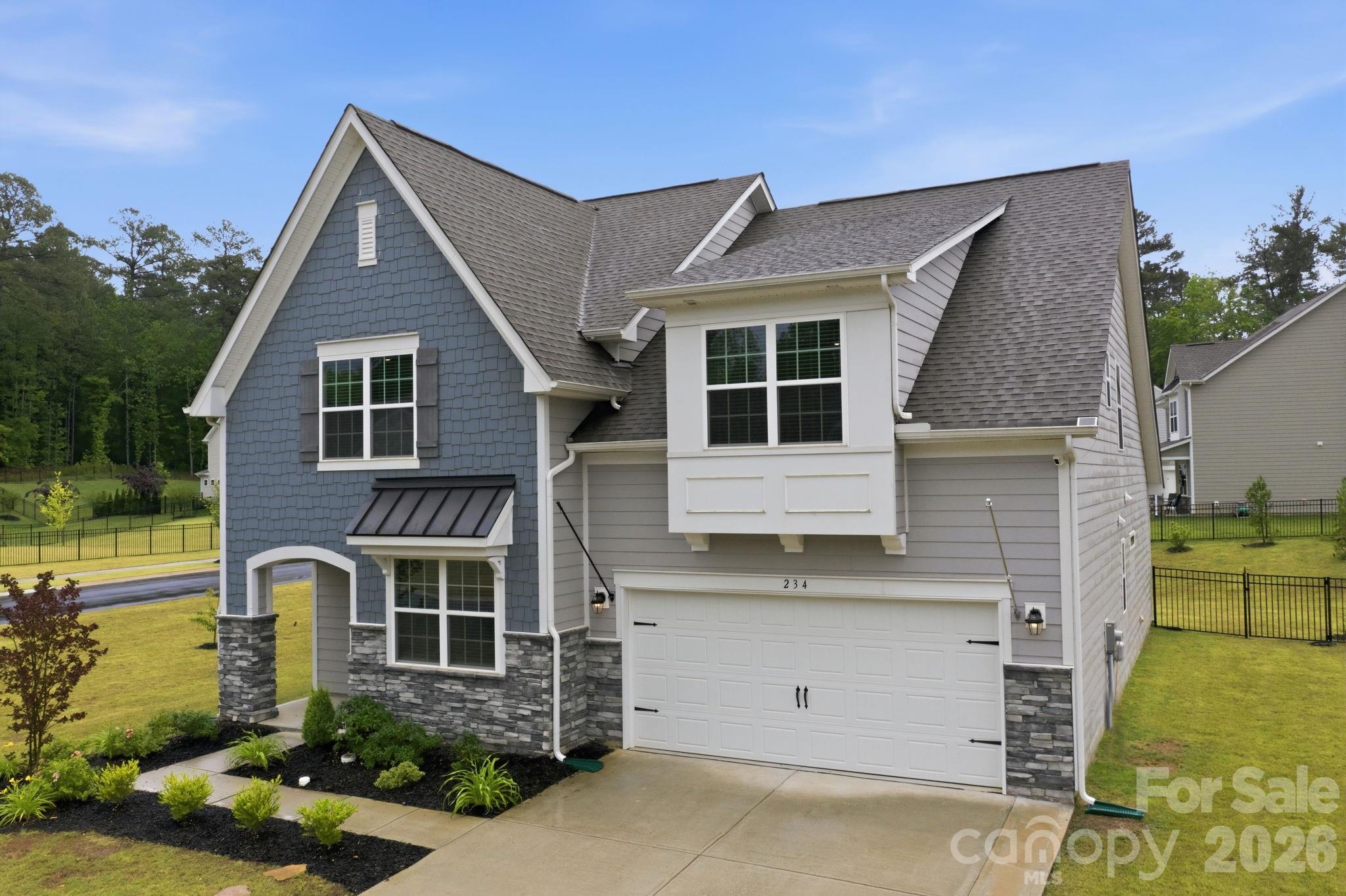 234 Hamptons Cove Road Troutman, NC 28166 - Photo 1 of 32 a front view of a house with a yard