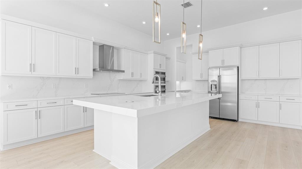 8447 Southwest Felicita Way Port St. Lucie, FL 34987 - Photo 13 of 92 a kitchen with stainless steel appliances white cabinets and a sink