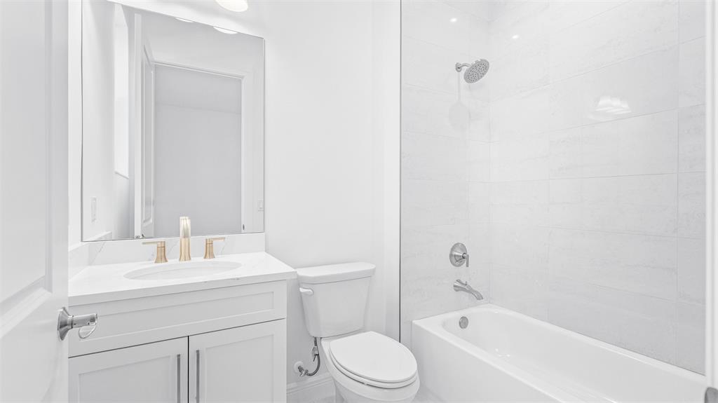 8447 Southwest Felicita Way Port St. Lucie, FL 34987 - Photo 30 of 92 a bathroom with a sink a toilet and shower