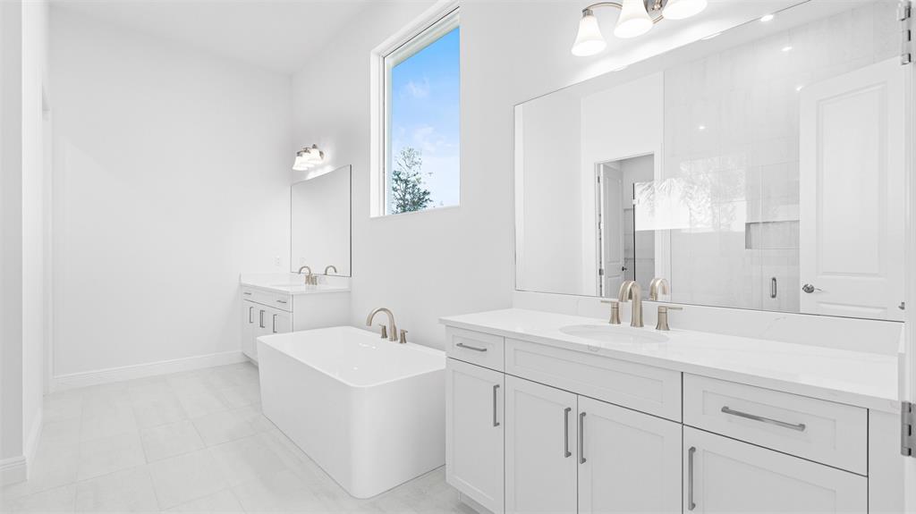 8447 Southwest Felicita Way Port St. Lucie, FL 34987 - Photo 35 of 92 a bathroom with double sink and a mirror