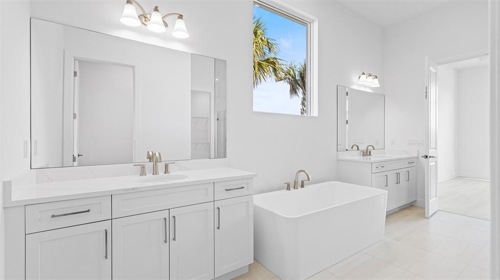 8447 Southwest Felicita Way Port St. Lucie, FL 34987 - Photo 36 of 92 a bathroom with a sink a vanity and a mirror