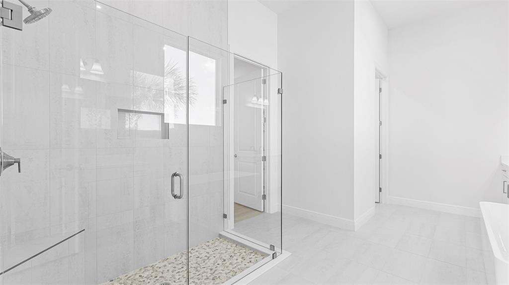 8447 Southwest Felicita Way Port St. Lucie, FL 34987 - Photo 38 of 92 a bathroom with a shower and a glass door