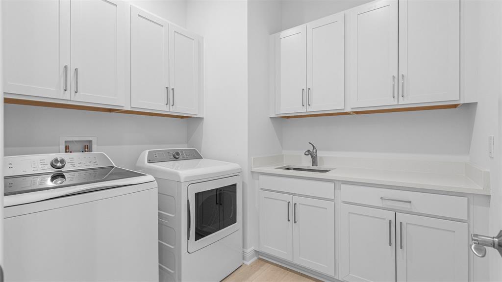 8447 Southwest Felicita Way Port St. Lucie, FL 34987 - Photo 49 of 92 a kitchen with white cabinets and sink