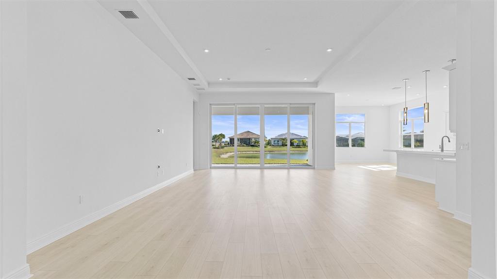 8447 Southwest Felicita Way Port St. Lucie, FL 34987 - Photo 7 of 92 a view of an empty room and kitchen with a window