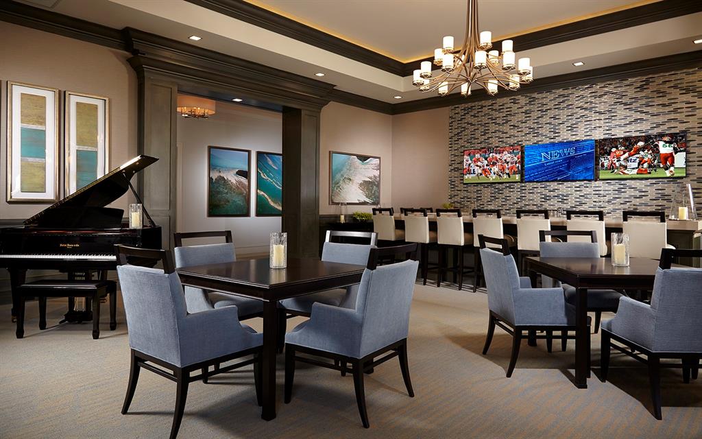 8447 Southwest Felicita Way Port St. Lucie, FL 34987 - Photo 71 of 92 a view of a dining room with furniture and chandelier