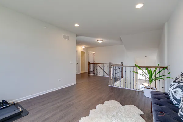 a view of a livingroom with furniture hardwood floor and staircase
