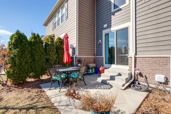 a view of a backyard with furniture and a fire pit