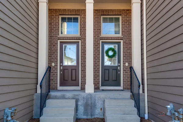 a view of front door of house and stairs