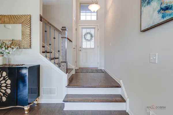 a view of staircase with white walls and a mirror