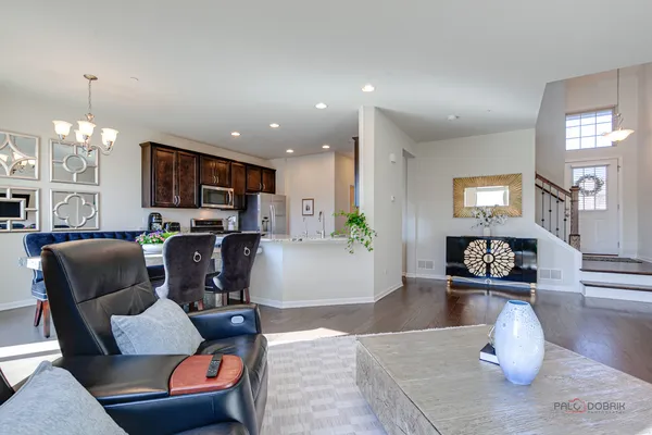 a living room with furniture and a chandelier