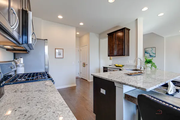 a kitchen with granite countertop wooden cabinets and a granite counter tops