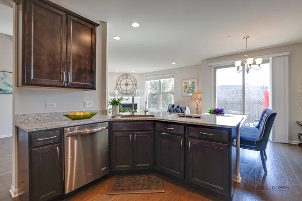 a kitchen with stainless steel appliances granite countertop a sink a stove and a refrigerator