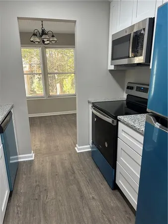 a kitchen with wooden floors and a microwave