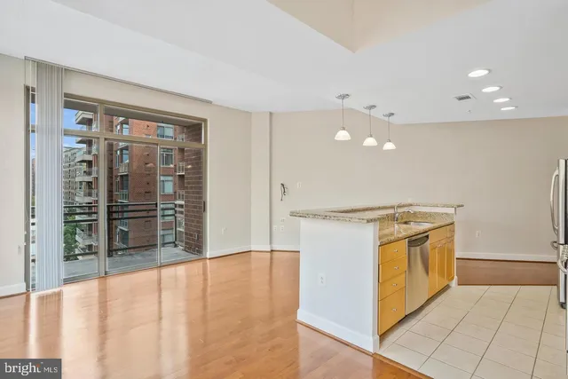 a view of a kitchen with a sink and a large window