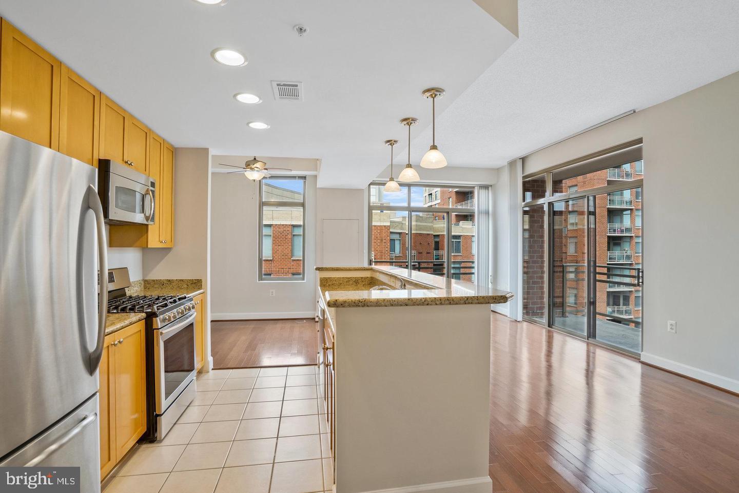 3650 South Glebe Road, Unit 638 Arlington, VA 22202 - Photo 4 of 35 a kitchen with stainless steel appliances granite countertop a refrigerator a stove and a sink