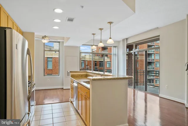 a kitchen with stainless steel appliances granite countertop a refrigerator and a sink