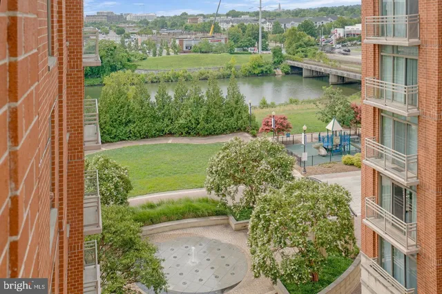 an aerial view of a house with garden space and lake view