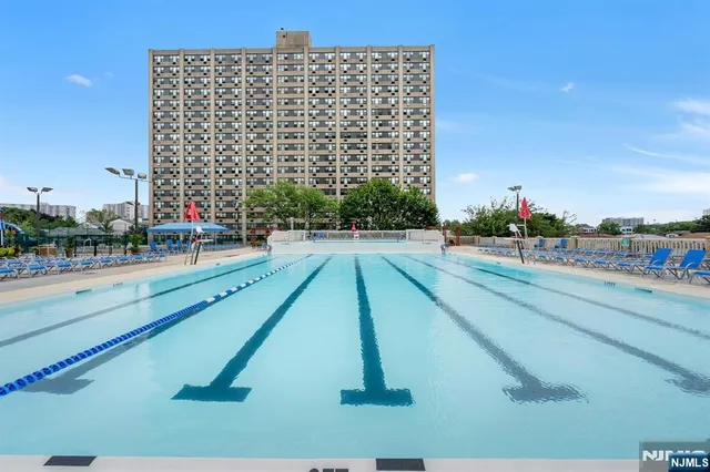 a view of yard with swimming pool and seating