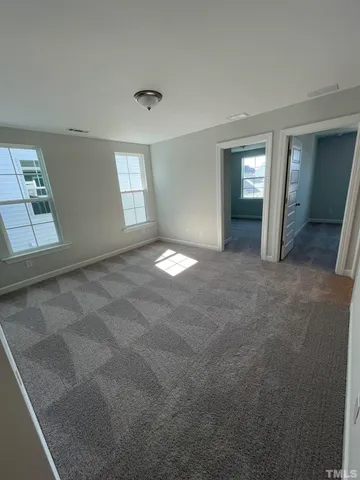 an empty room with windows and entrance