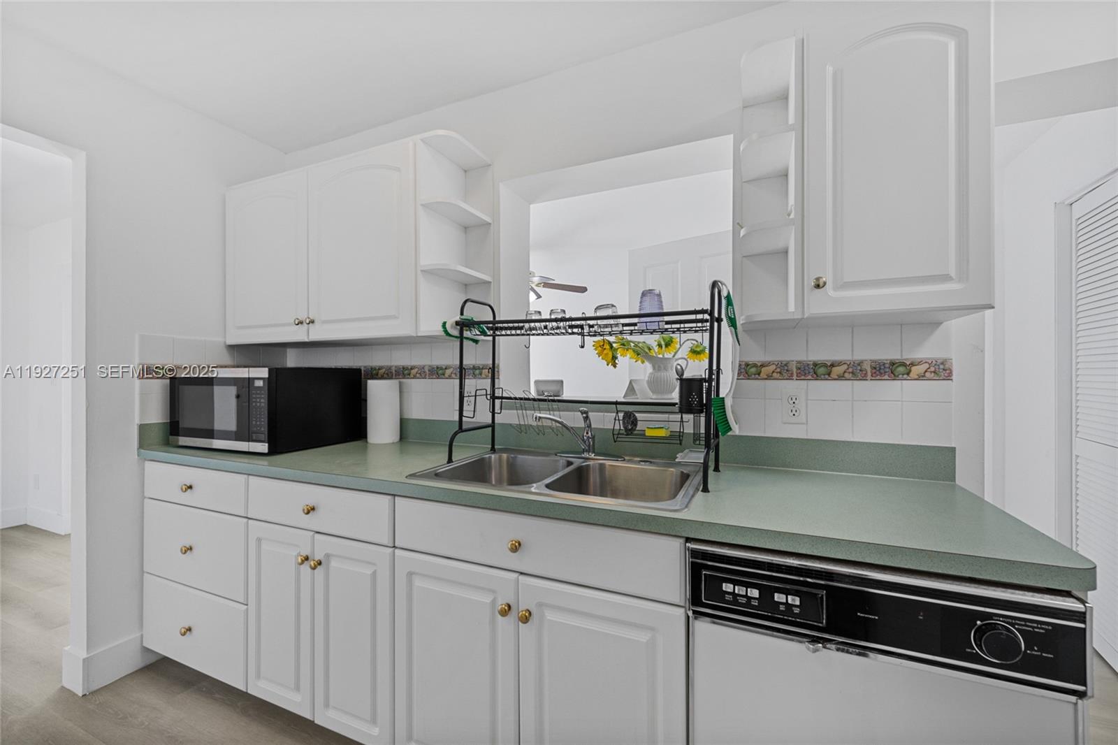 9864 Southwest 26th Terrace Miami, FL 33165 - Photo 12 of 40 a kitchen with appliances a sink and cabinets