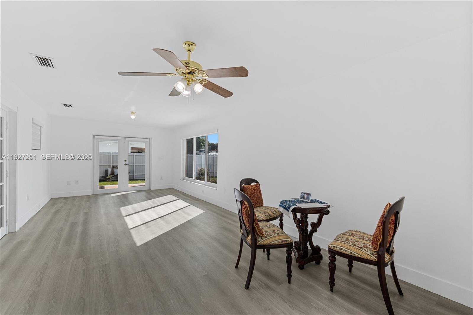 9864 Southwest 26th Terrace Miami, FL 33165 - Photo 14 of 40 a view of a dining room with furniture and wooden floor