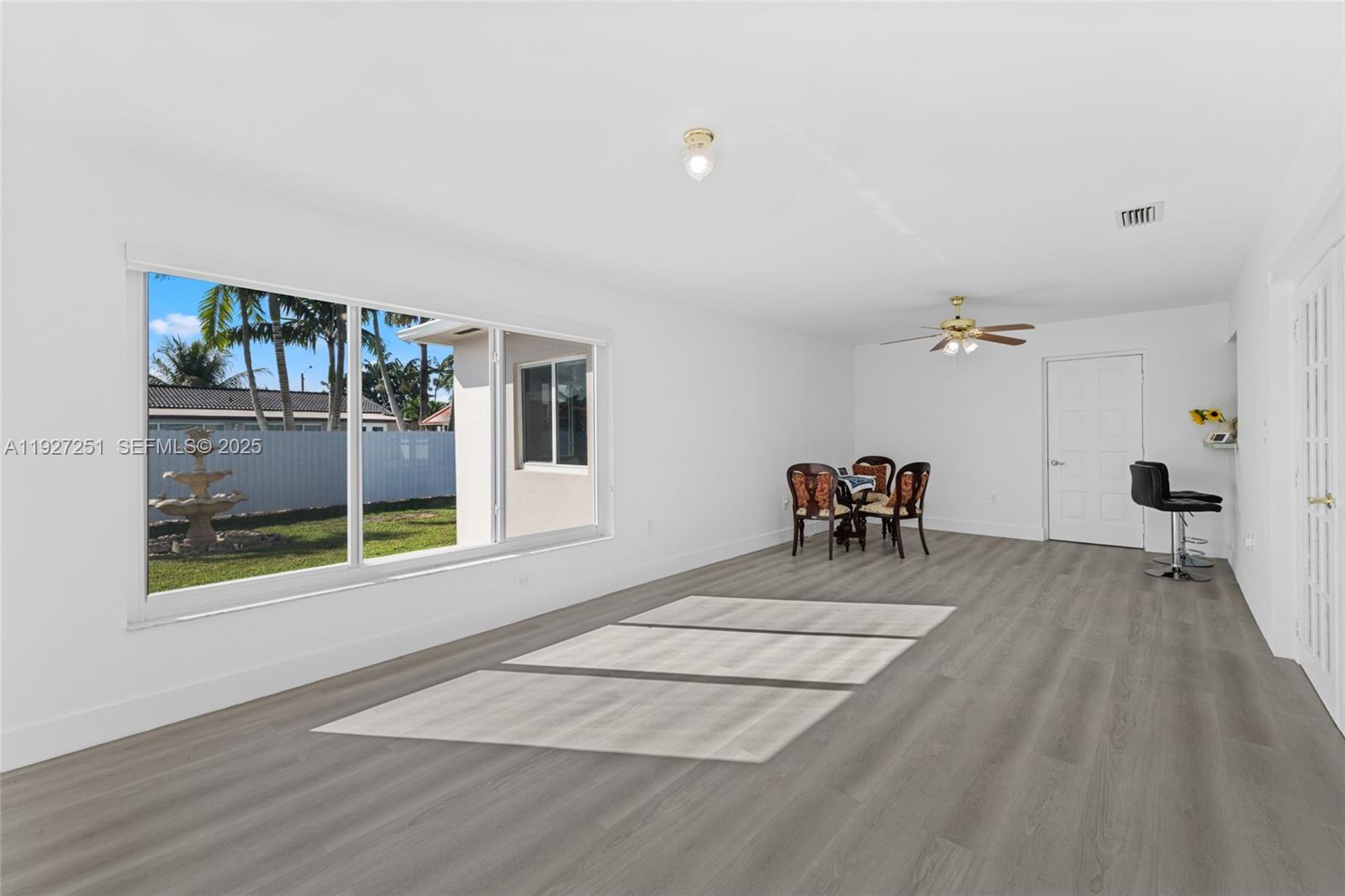 9864 Southwest 26th Terrace Miami, FL 33165 - Photo 15 of 40 a dining room with a wooden floor and a ceiling fan