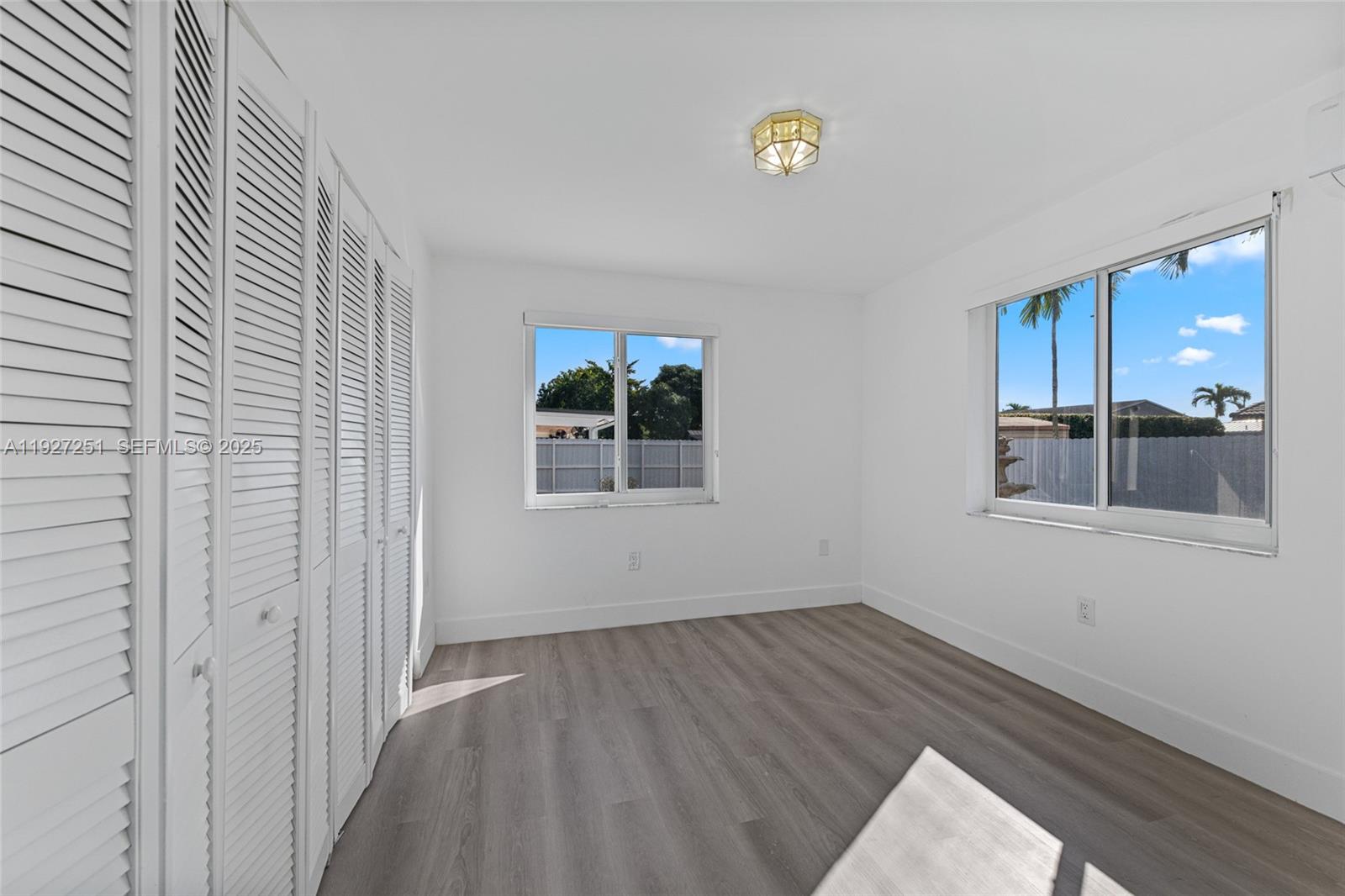 9864 Southwest 26th Terrace Miami, FL 33165 - Photo 19 of 40 a view of a room with wooden floor and window