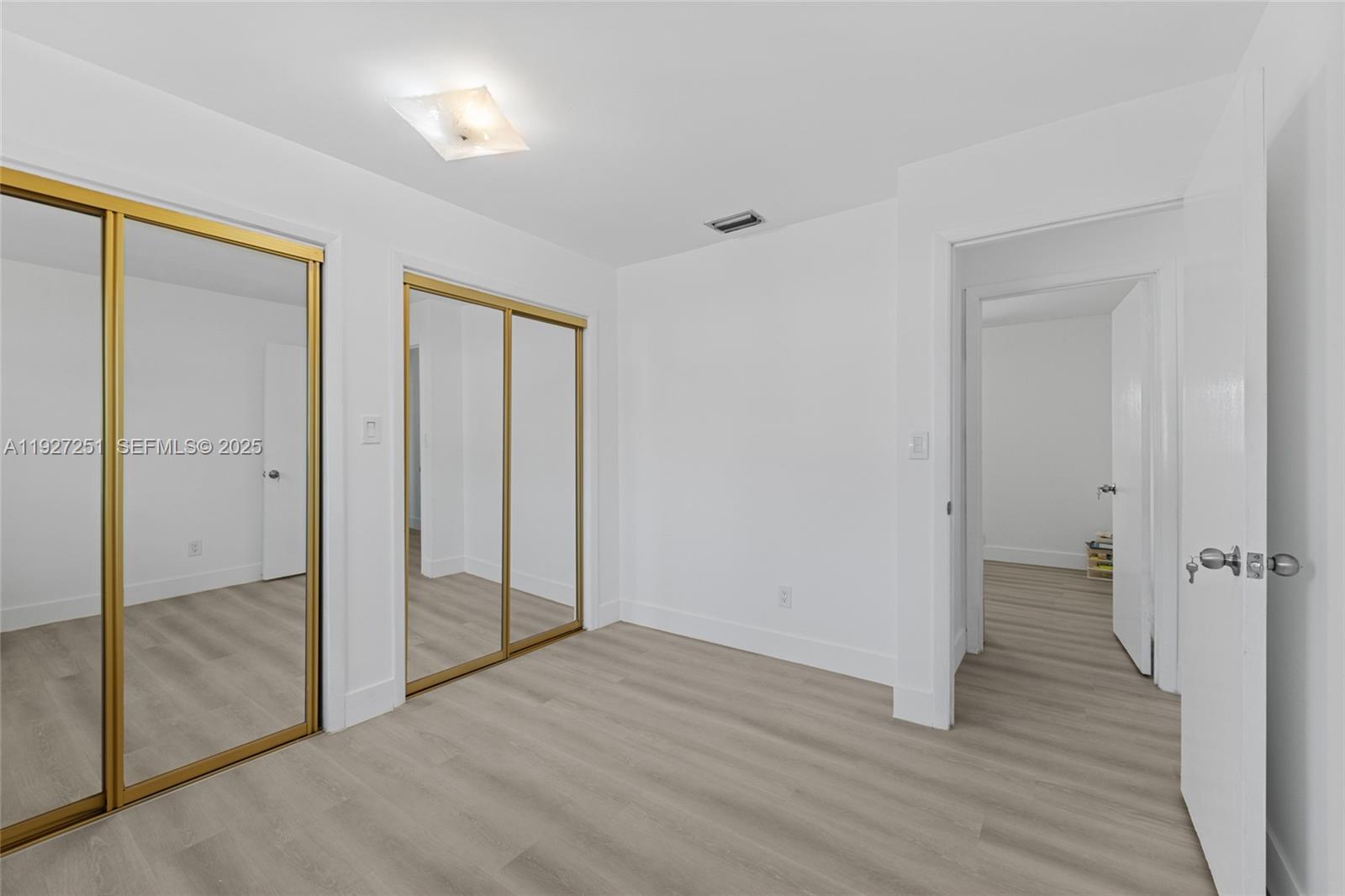 9864 Southwest 26th Terrace Miami, FL 33165 - Photo 26 of 40 wooden floor and closet in a room