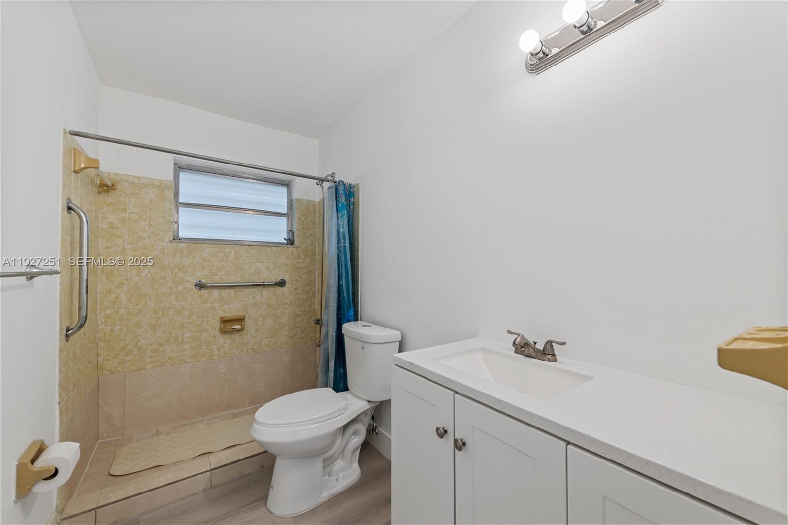 9864 Southwest 26th Terrace Miami, FL 33165 - Photo 28 of 40 a bathroom with a sink a toilet and shower